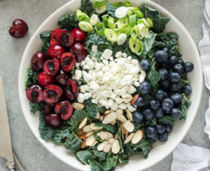 SUMMER KALE SALAD WITH BLUEBERRIES, CHERRIES, AND GOAT CHEESE
